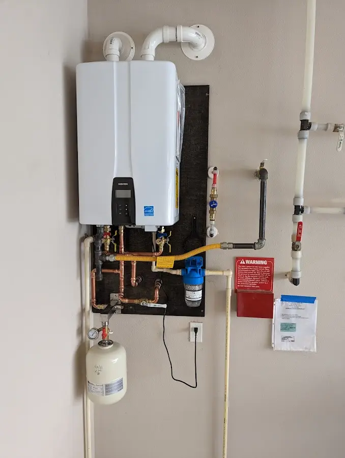 Professional plumber installing copper piping in a Huntersville home